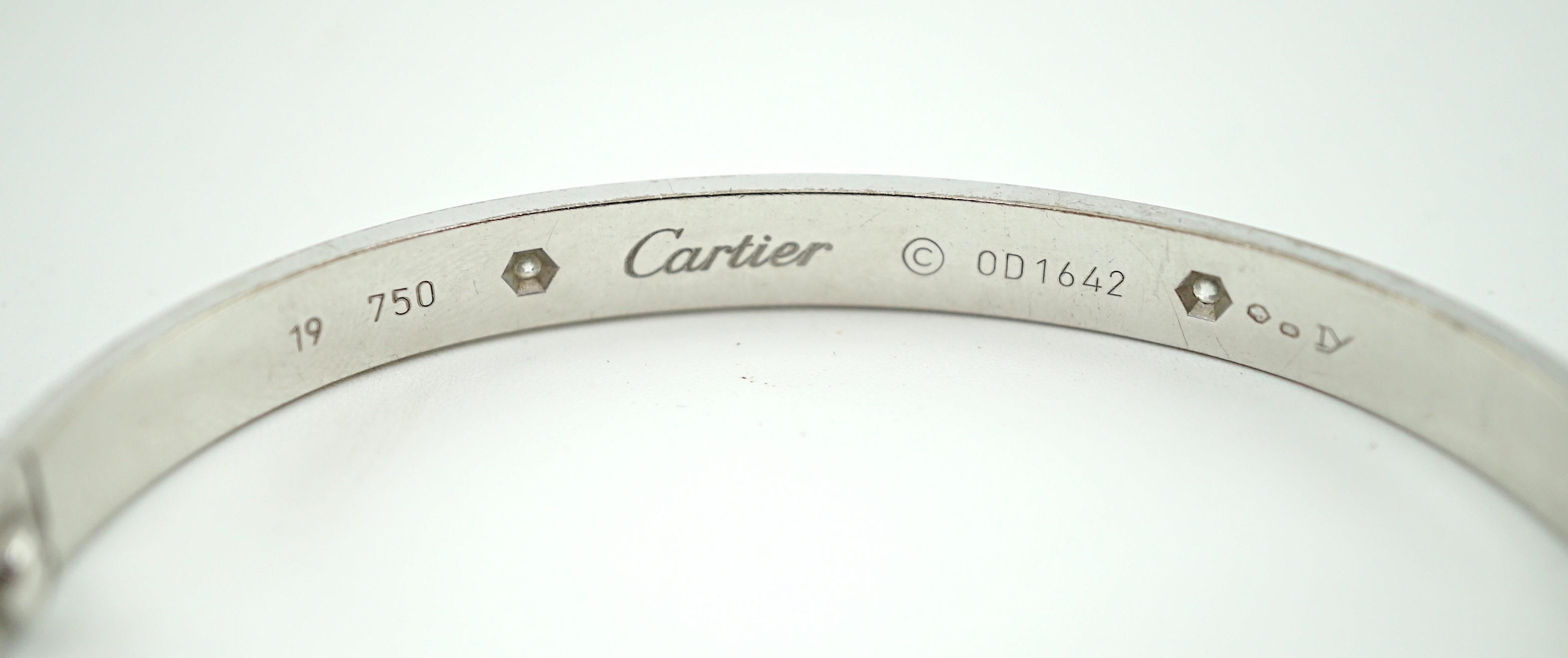 A modern Cartier 750 white gold and four stone gypsy set diamond 'Love' bangle